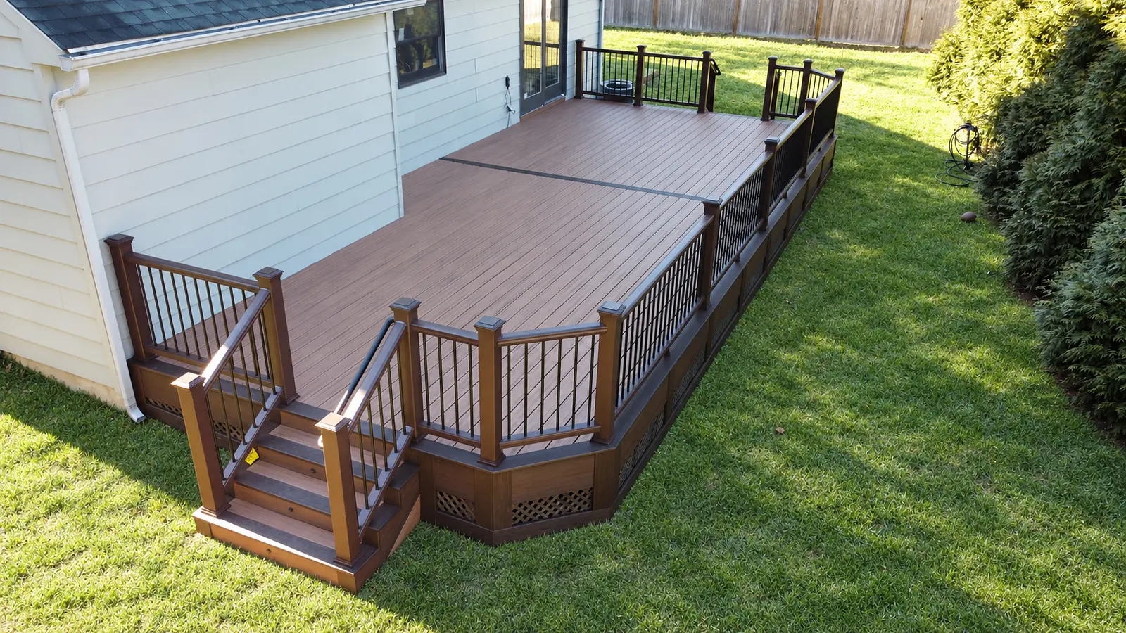 Overhead view of a brown deck and stairs beside a home — Zenna Decks portfolio